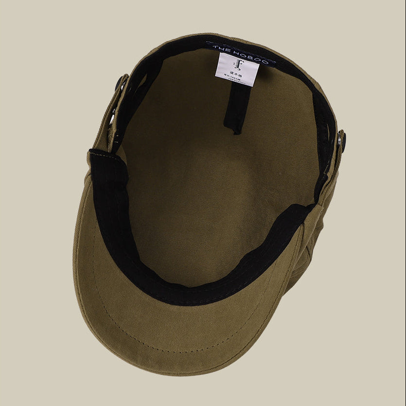 Brown cap with black interior on a beige background, featuring the brand 'Slate'.