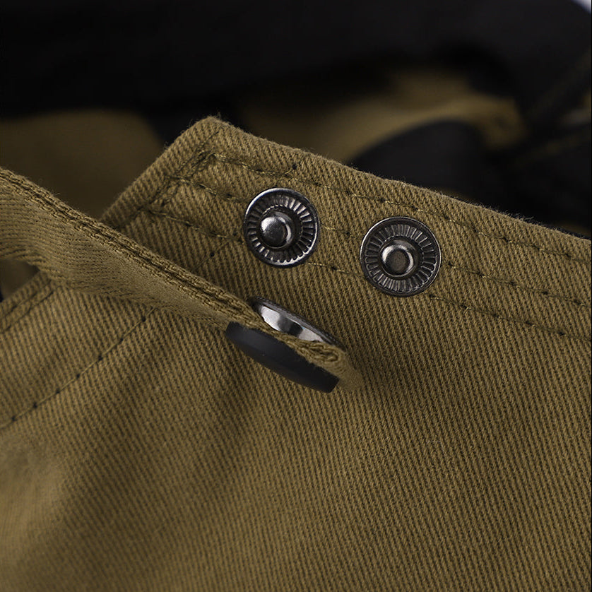 Close-up of a brown fabric with buttons and a brand logo on the left.