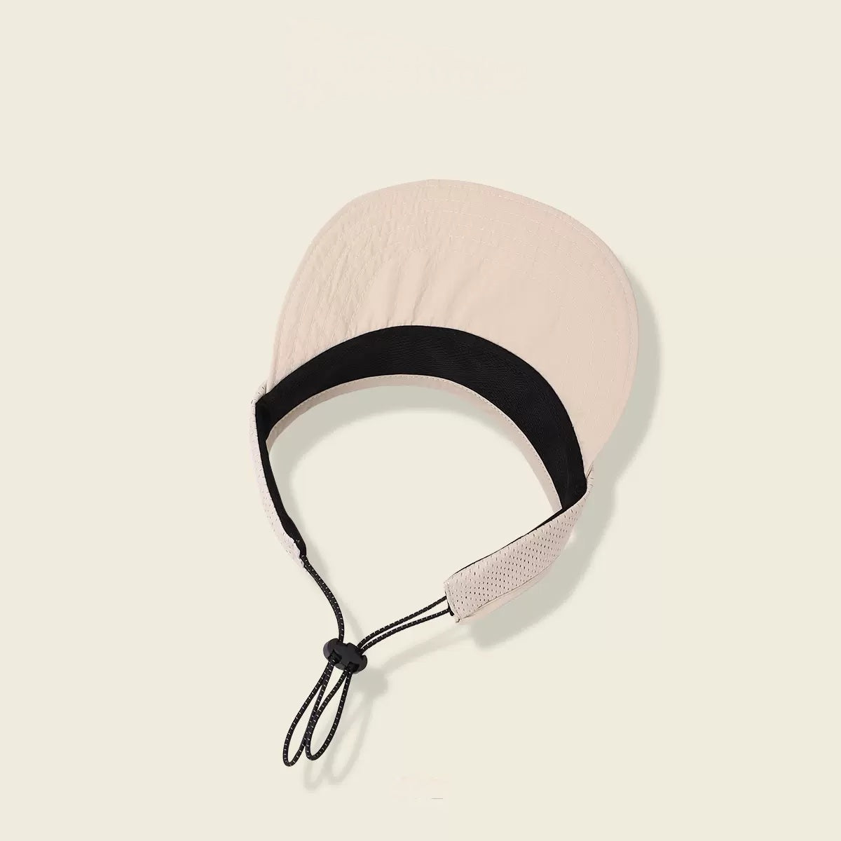 Beige headband with black strap on a beige background