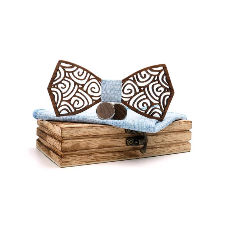 Wooden bow tie with decorative patterns on a wooden box with a white background