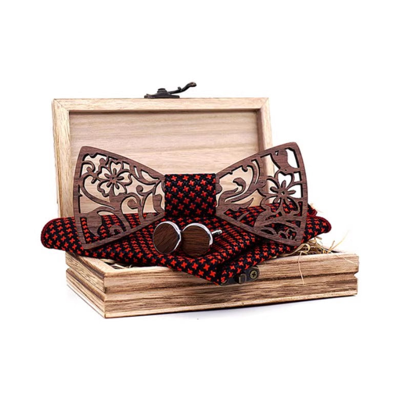 Wooden bow tie with decorative patterns in a wooden box on a white background