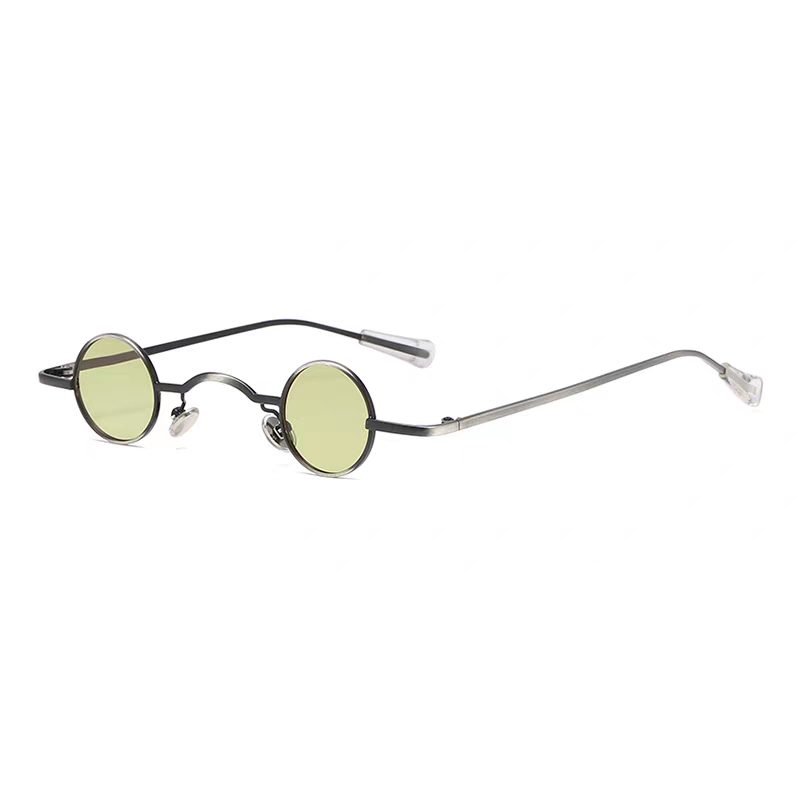 Round sunglasses with thin metal frame and green lenses on a white background.