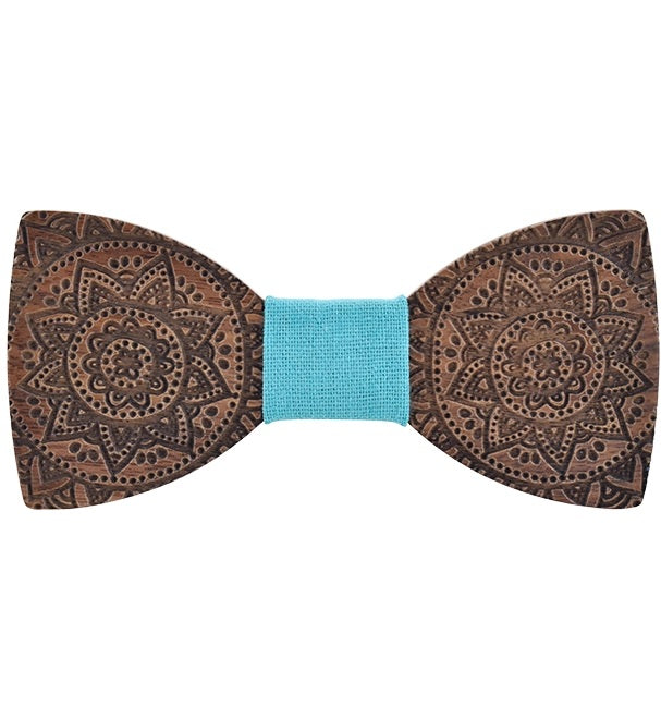 Wooden bow tie with intricate patterns and a blue center on a white background