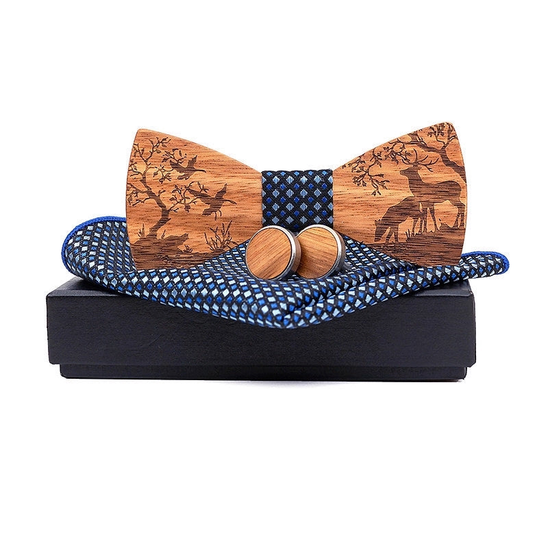 Wooden bow tie with deer design, cufflinks, and blue patterned tie on a black box against a white background