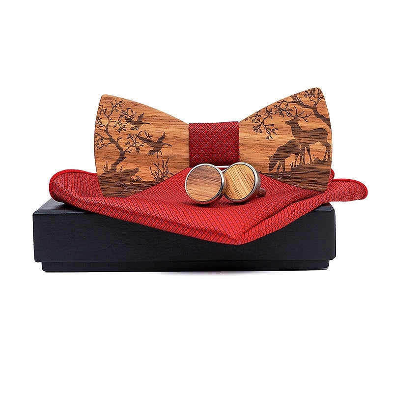 Wooden bow tie and cufflinks set with red fabric on a black box against a white background