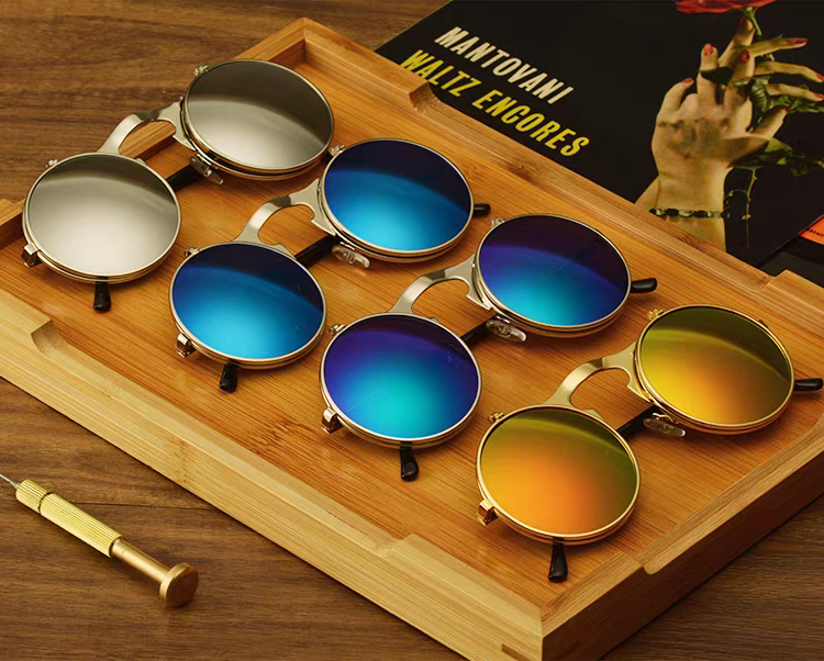 Set of colorful sunglasses on a wooden tray