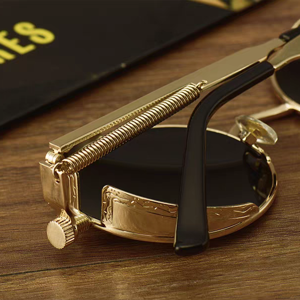 Gold-framed sunglasses with a black lens