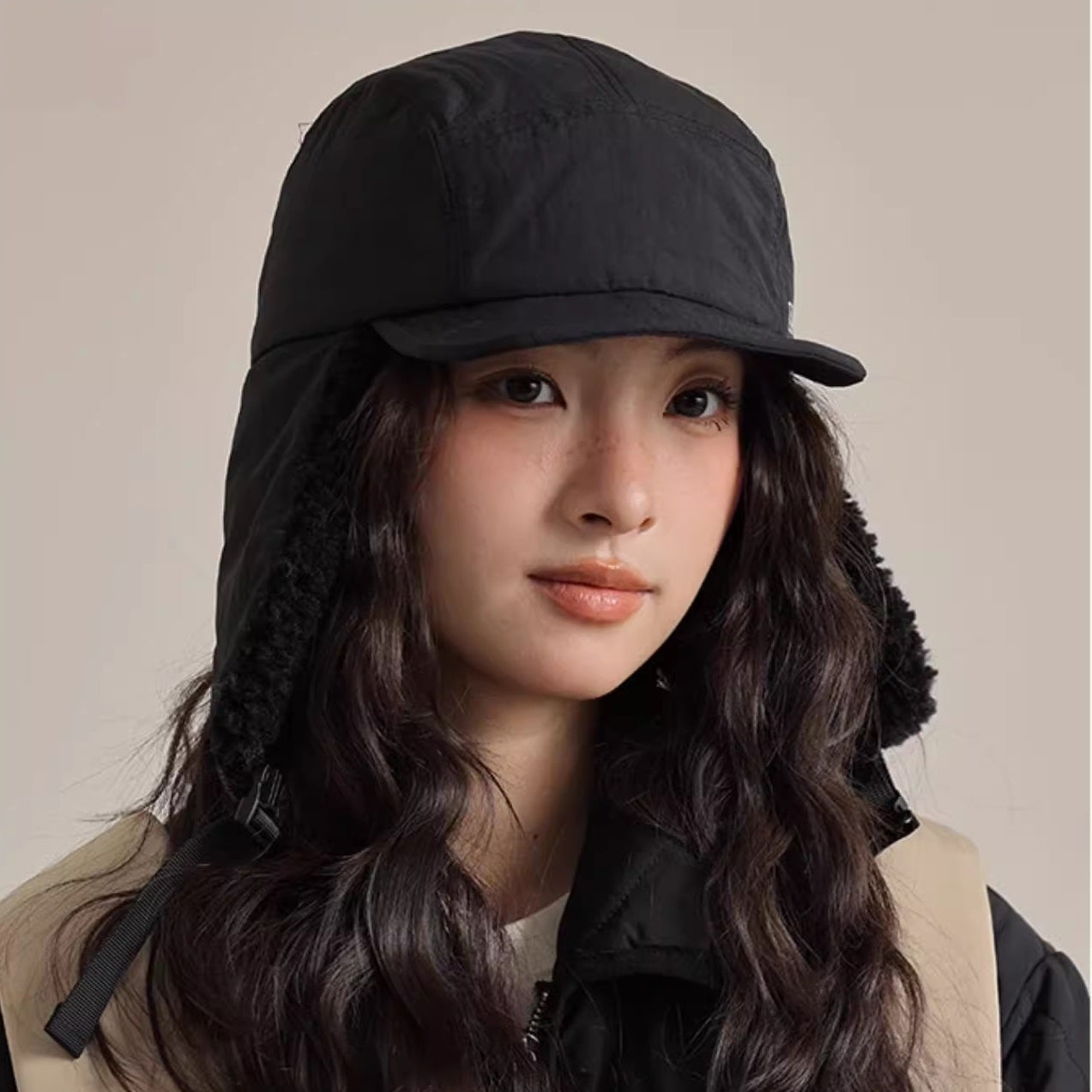 Person wearing a black cap and carrying a backpack with 'Model Show' text above.