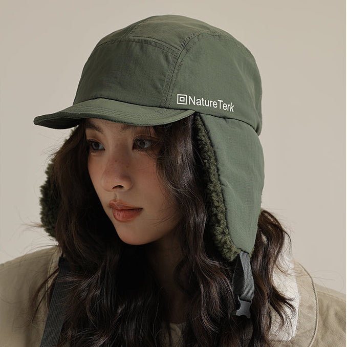 Person wearing a green cap with aNatureTek logo, with text about retro fashion and winter style.