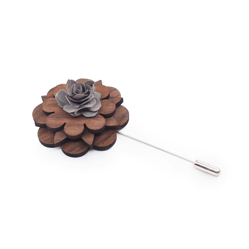 Wooden flower lapel pin with gray center on a white background