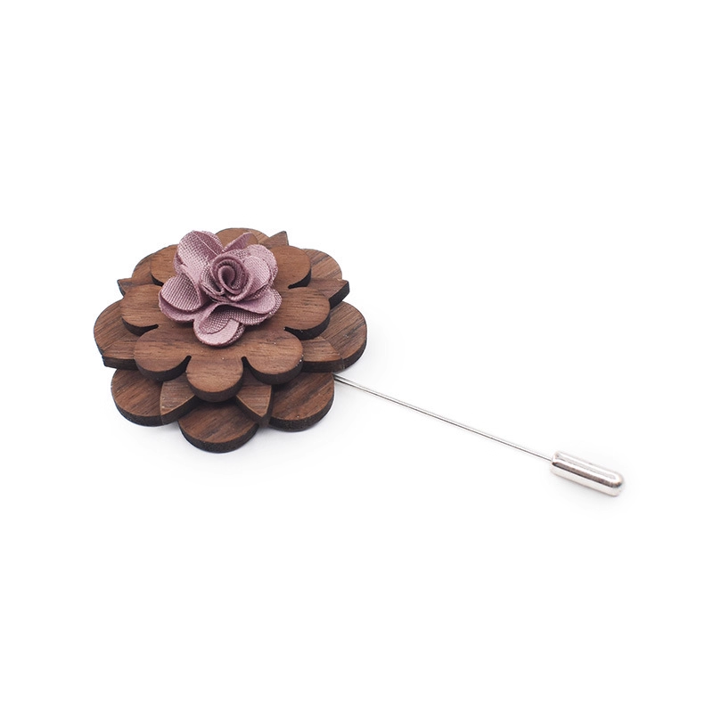 Wooden flower lapel pin with a pink center on a white background