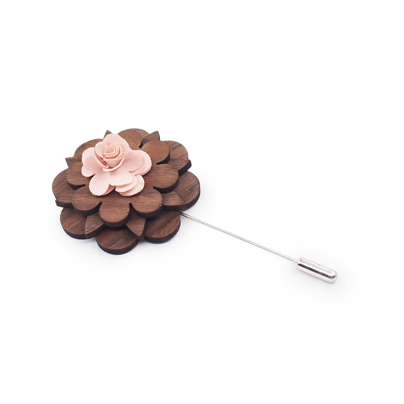 Wooden flower lapel pin with a pink center on a white background