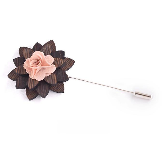 Floral lapel pin with wooden accents on a white background