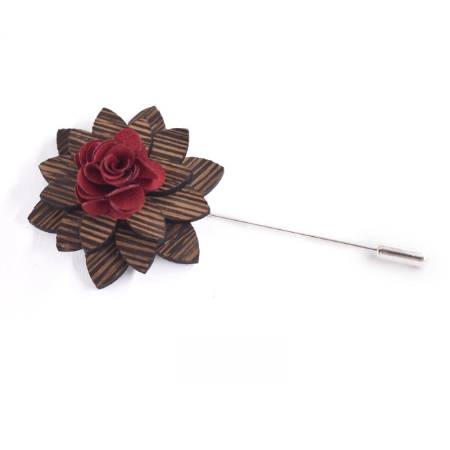 Floral lapel pin with red flower and brown leaves on a white background