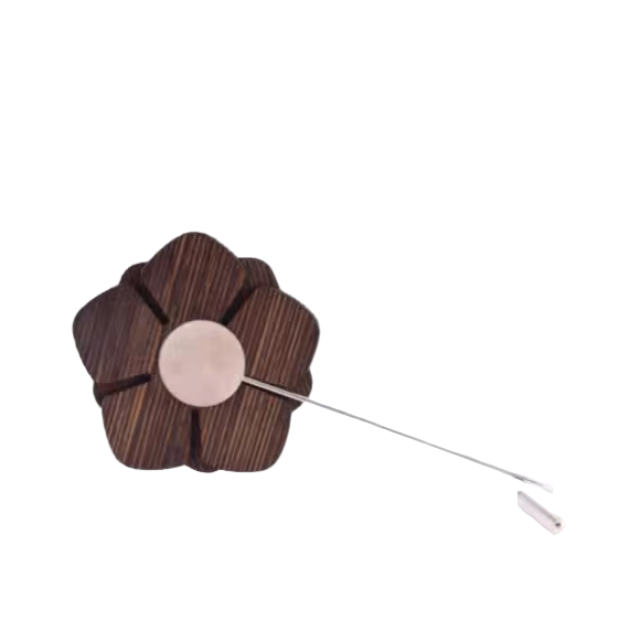 Wooden flower brooch with a silver pin on a white background