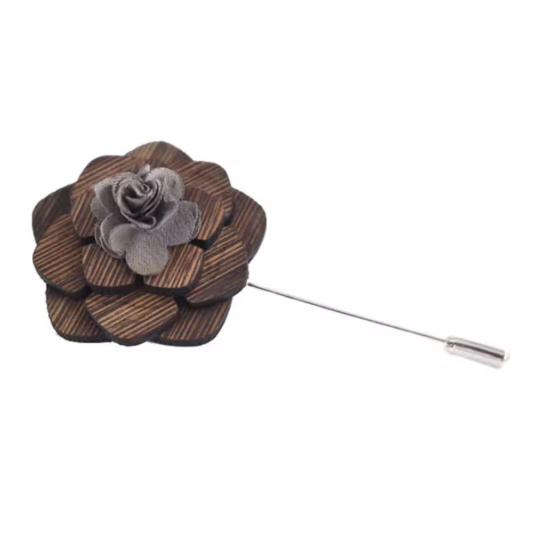 Wooden flower lapel pin with a gray center on a white background