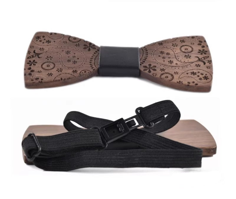 Wooden bow tie with floral pattern and black strap on a white background