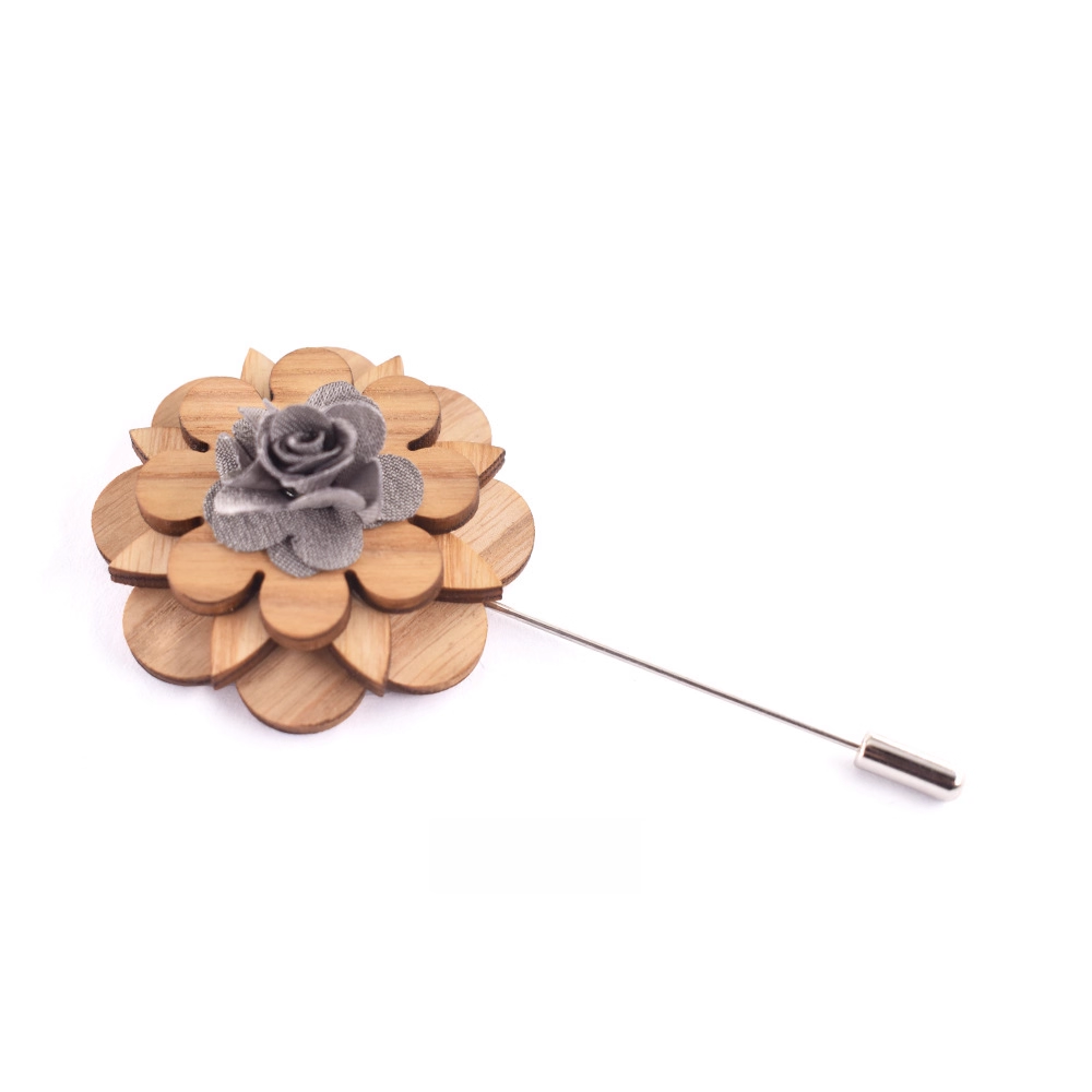 Wooden flower lapel pin with gray center on a white background