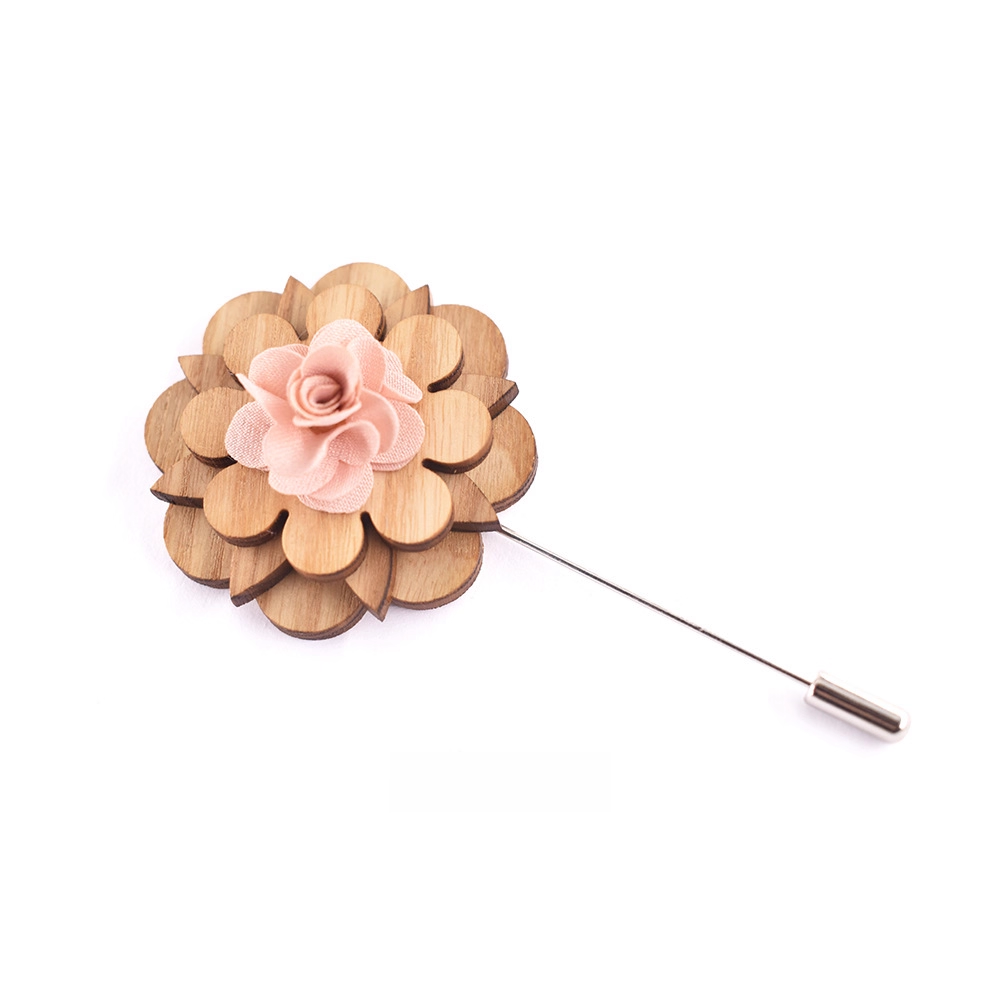 Wooden flower lapel pin with a pink center on a white background