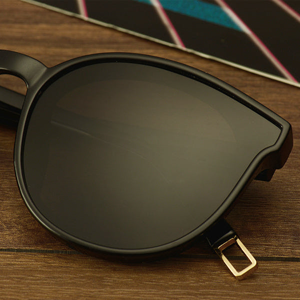 Sunglasses with dark lenses on a wooden surface