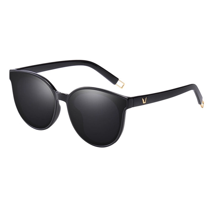 Black sunglasses with gold accents on a white background