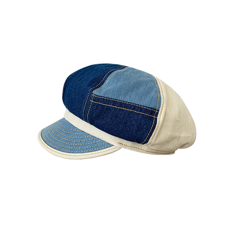 Two denim caps on a dark background