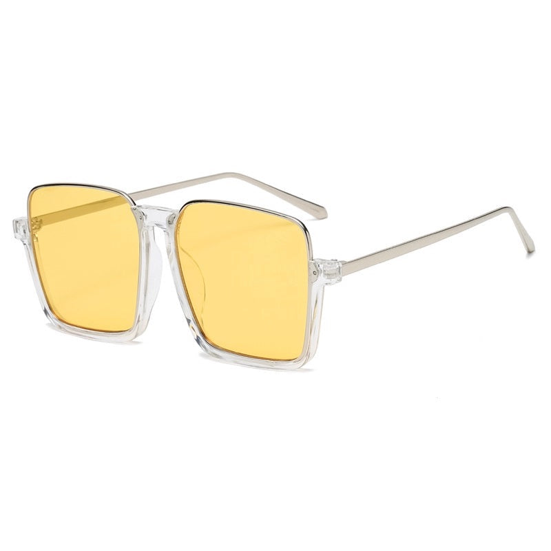 Sunglasses with yellow lenses and silver frame on a white background