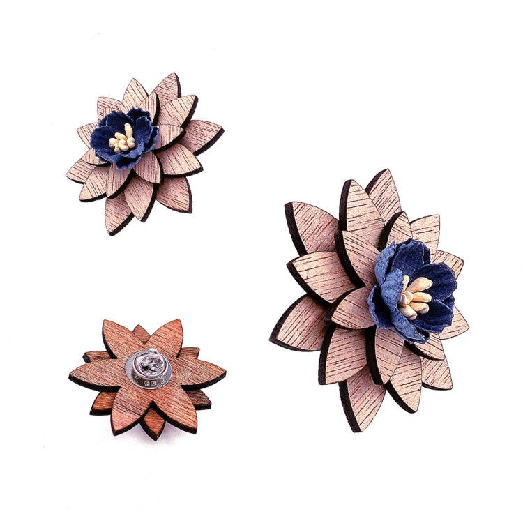 Wooden flower-shaped brooches with blue centers on a white background