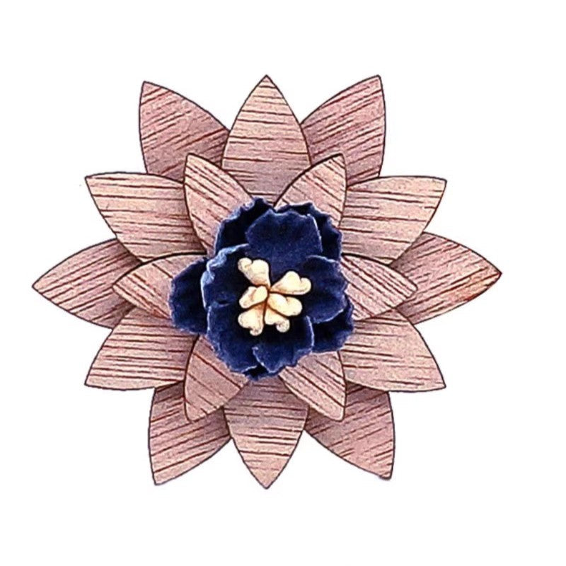 Floral brooch with pink wooden petals and a blue flower center on a white background