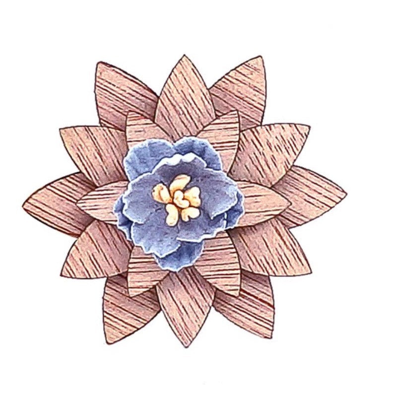 Decorative brooch with wooden and fabric design on a white background