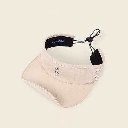 Beige visor cap with black strap on a light beige background
