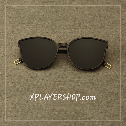Black sunglasses on a brown textured background with 'XPLAYERSHOP.com' text.