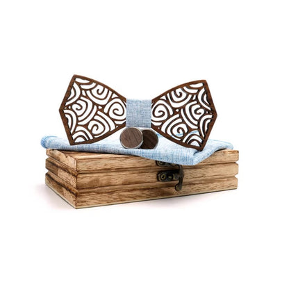 Wooden bow tie with decorative patterns on a wooden box with a white background
