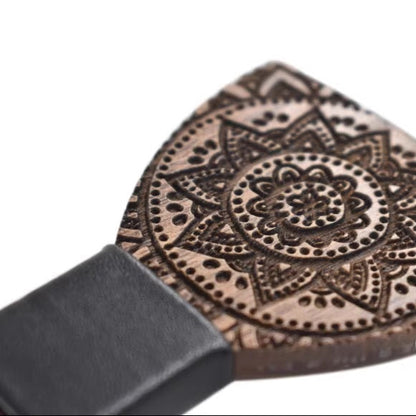 Wooden spatula with intricate mandala design on a white background