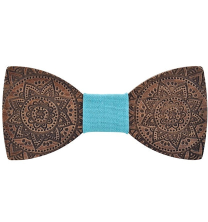 Wooden bow tie with intricate patterns and a blue center on a white background