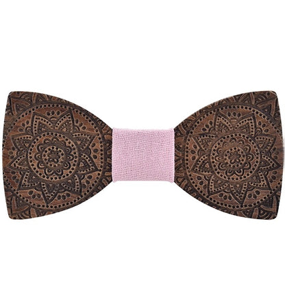 Wooden bow tie with intricate patterns on a white background