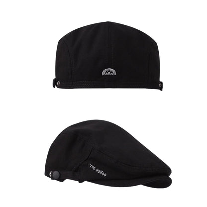 Two black hats with brand logos on a gray background