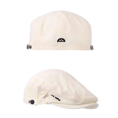 Two white caps with black logos on a blue background
