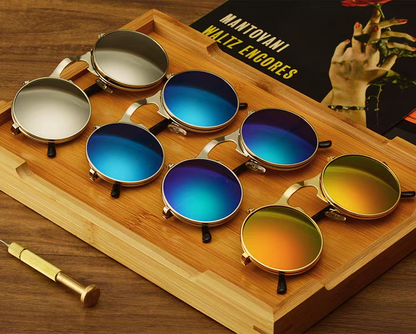 Set of colorful sunglasses on a wooden tray 