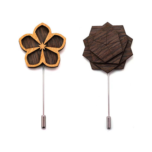 Two wooden flower-shaped lapel pins on a white background