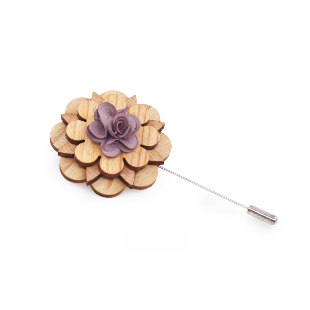 Wooden flower lapel pin with a purple center on a white background