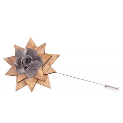 Wooden star-shaped brooch with a gray flower on a white background