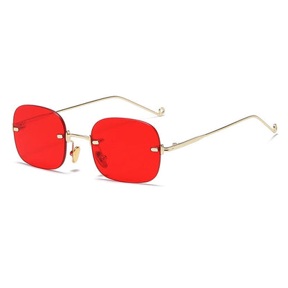 Sunglasses with red lenses and gold frames on a white background