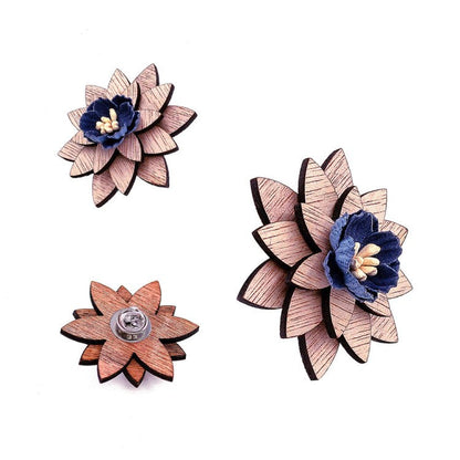 Wooden flower-shaped brooches with blue centers on a white background