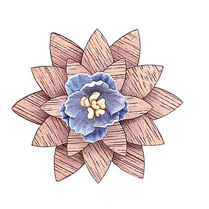 Decorative brooch with wooden and fabric design on a white background